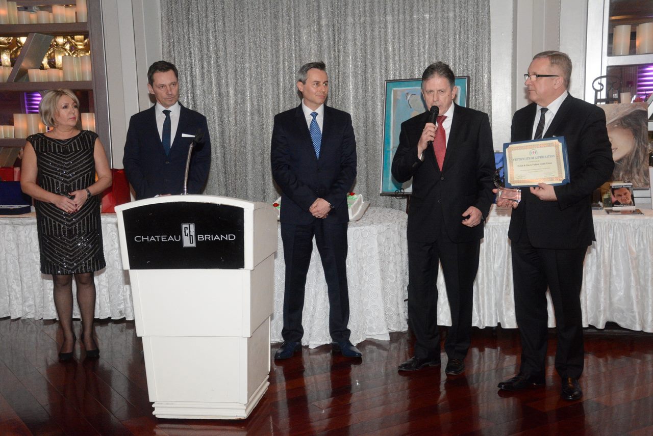 PSFCU Board Of Directors Chairman Krzysztof Matyszczyk accepts an award