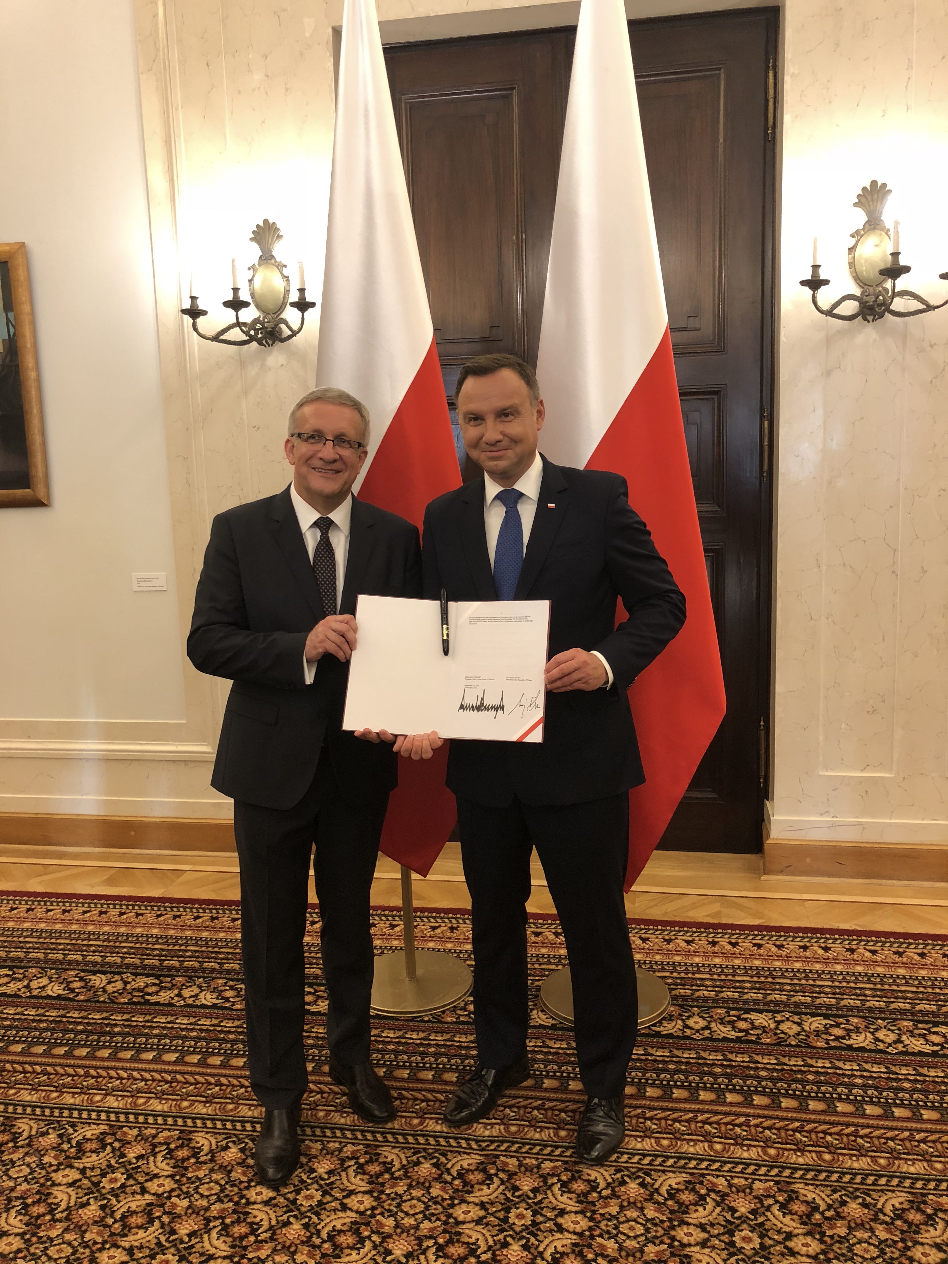 President of Poland gives PSFCU a copy a copy of the Declaration of Cooperation together with the original marker